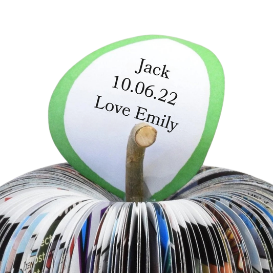 Close up of personalised leaf on superhero book apple showing custom anniversary message