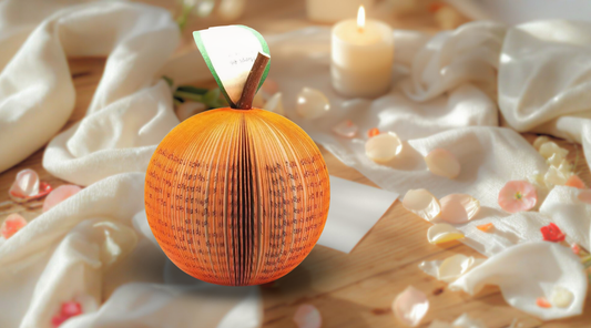 Handmade orange book art fruit anniversary gift styled with candlelight and soft romantic setting for a 4th wedding anniversary.