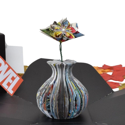 Close-up of Mini Superhero Vase and Flowers vase showing hand-cut book page detail