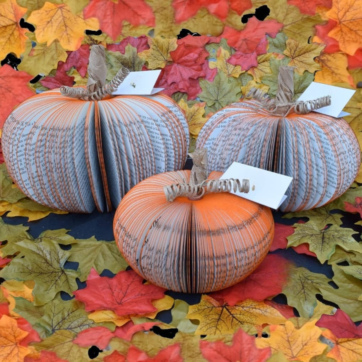 Set of 3 handmade book pumpkin displayed in seasonal setting
