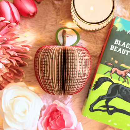 Close-up of Black Beauty book apple showing hand-cut book pages detail