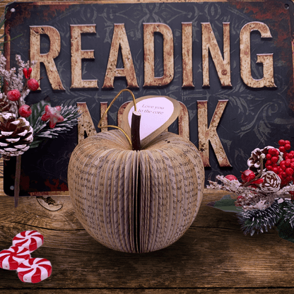 Hanging gold glitter apple on neutral background, unique handmade literary gift