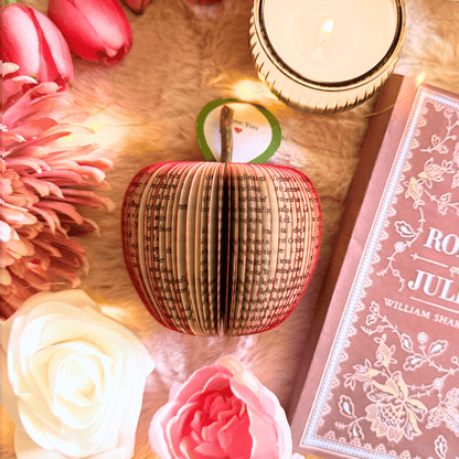 Romeo and Juliet book apple held in hands to show size, handmade paper anniversary gift