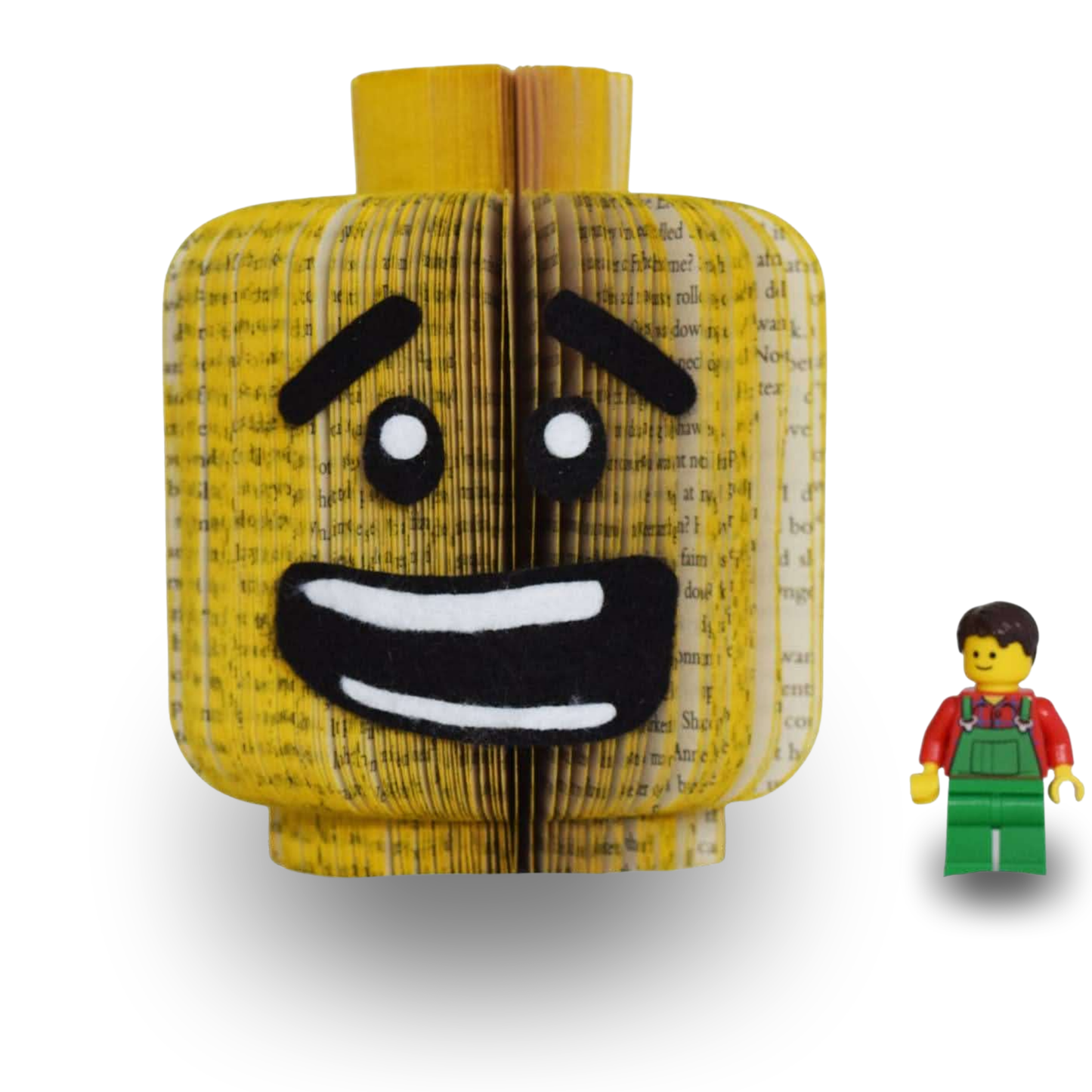 Handmade block head book art male face, hand-cut from real book pages, shown with toy figure for scale, figure not included