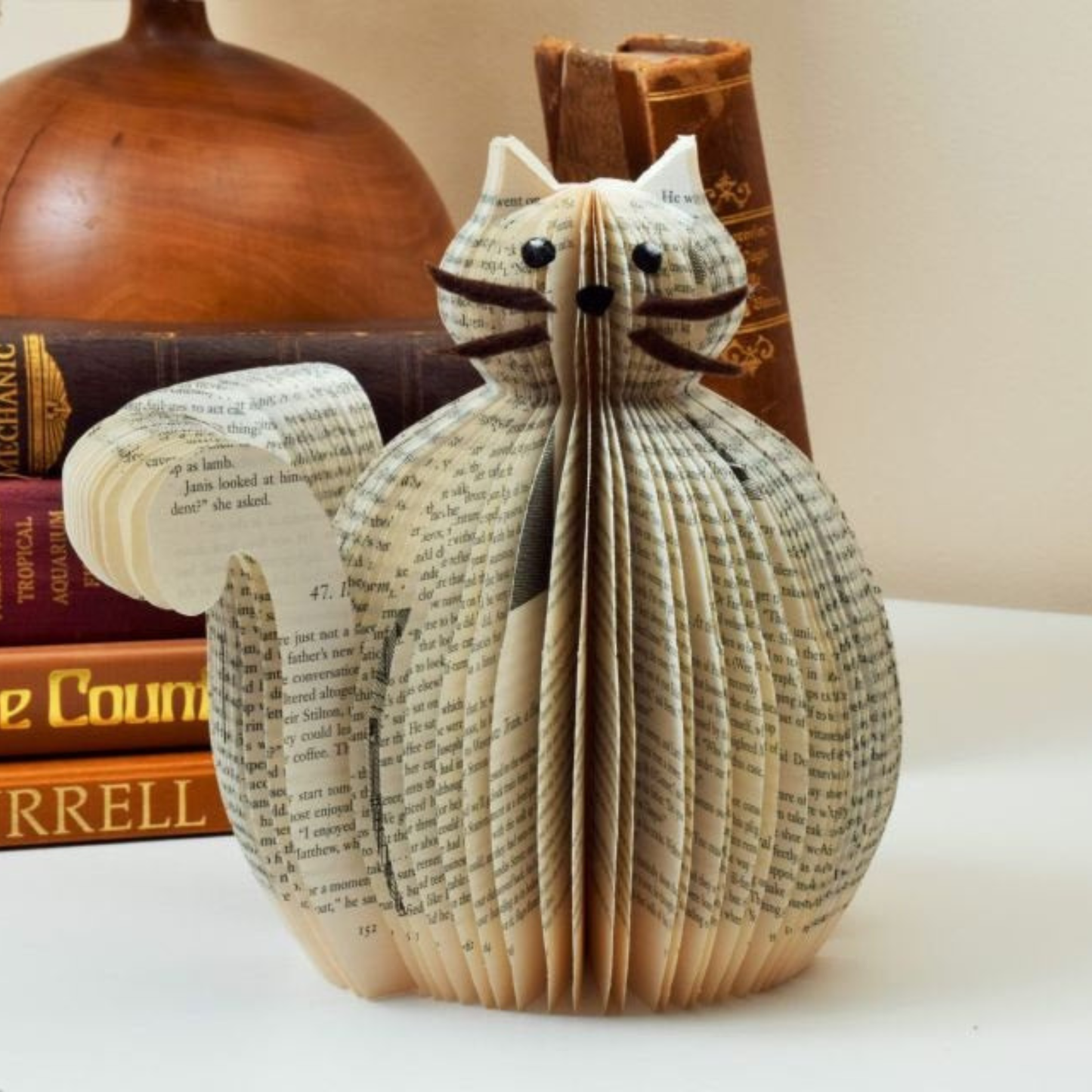 Book page cat displayed as a decorative handmade gift in a home setting