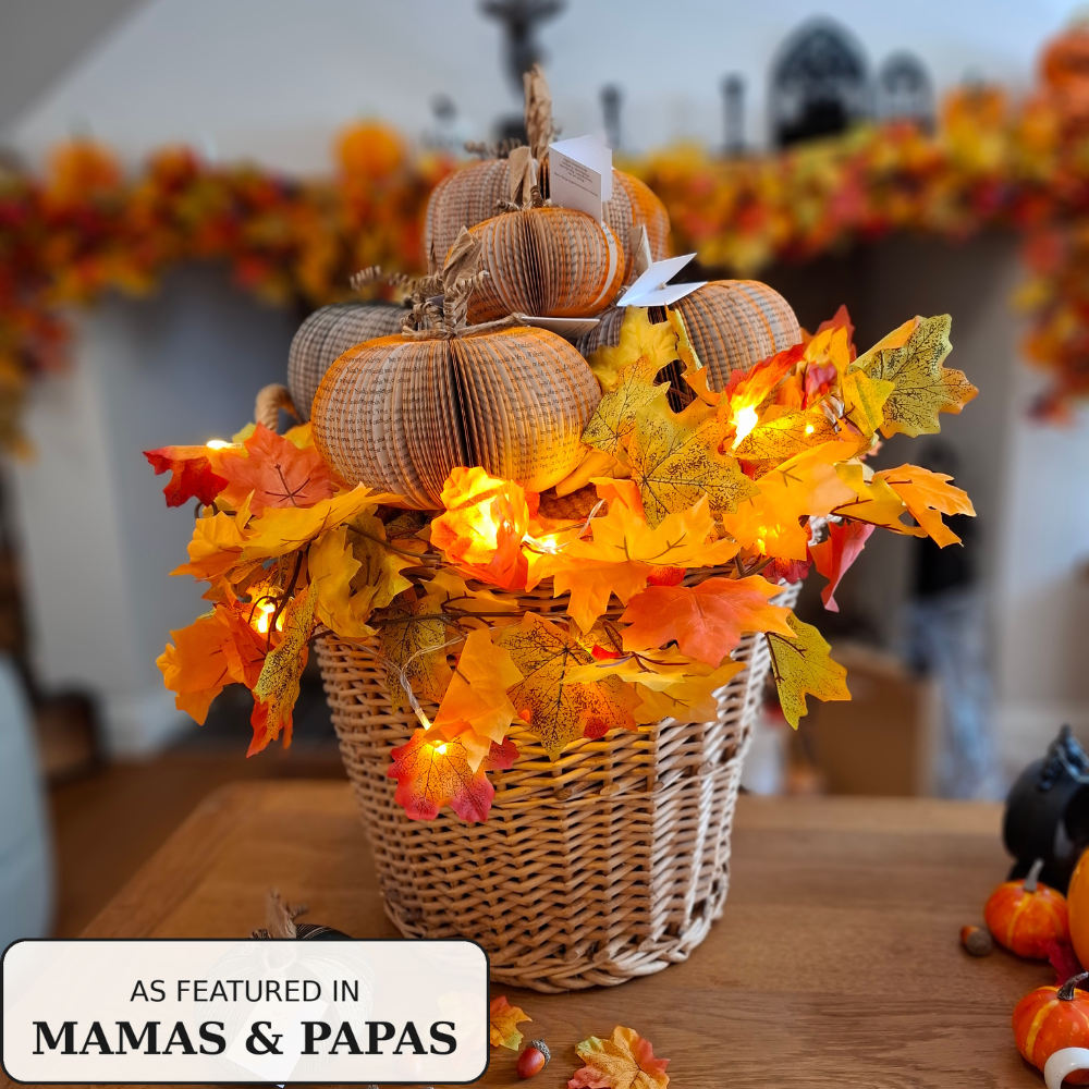 Handmade book pumpkin displayed with autumn garland on a mantelpiece, as featured in Mamas & Papas