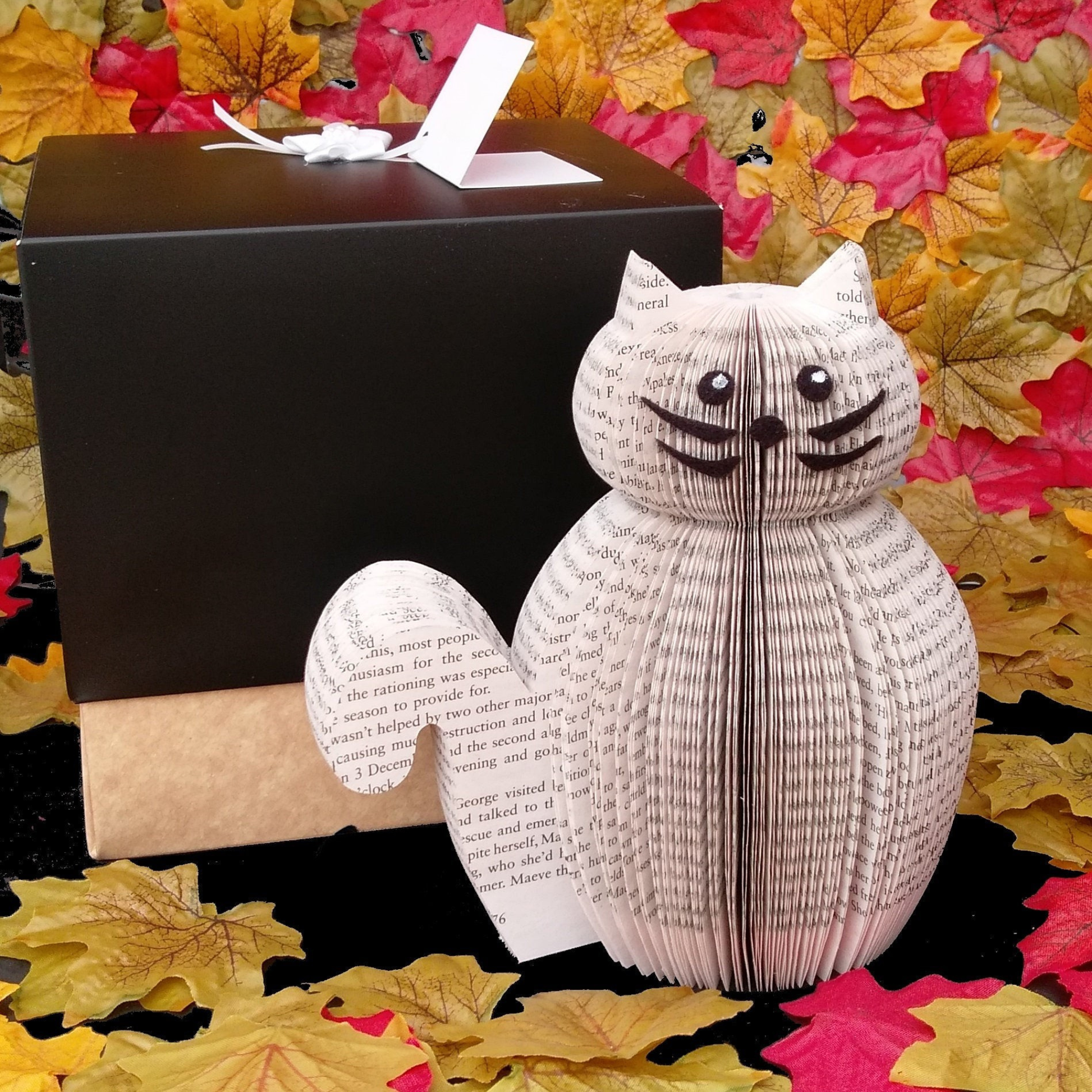 Handmade book page cat displayed in an autumn styled setting