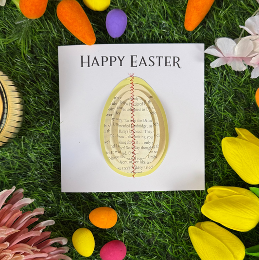 Handmade Easter card with book page egg design displayed upright