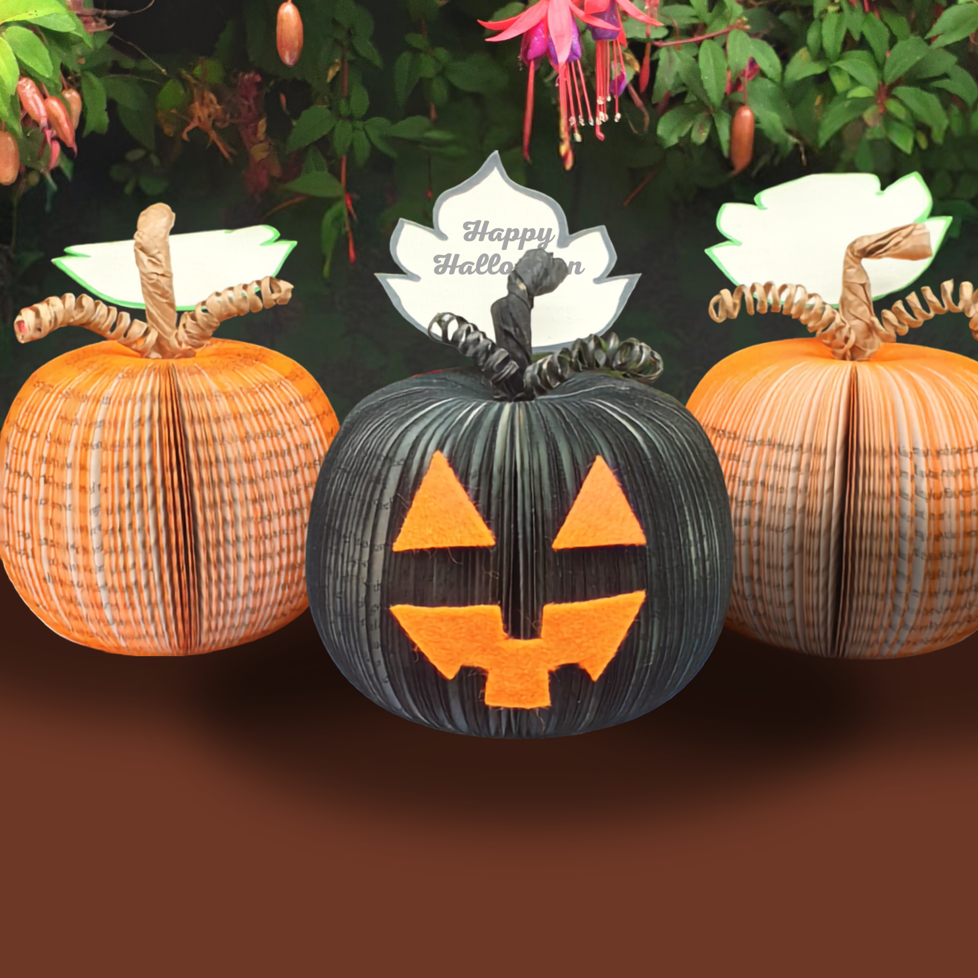 Handmade Jack O'Lantern book pumpkins in orange and black, hand-cut Halloween decorations