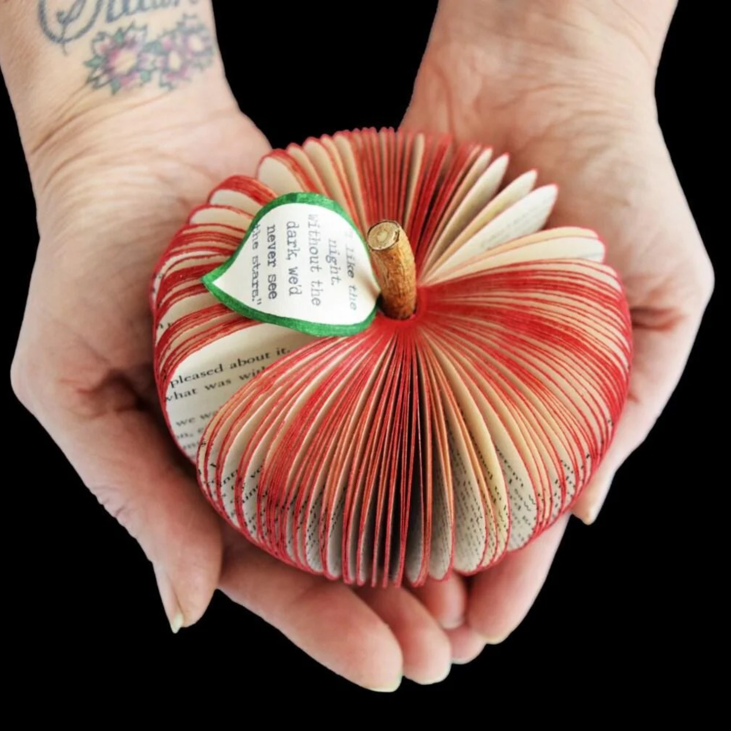 Personalised Twilight Saga book apple held in hands showing custom message on leaf