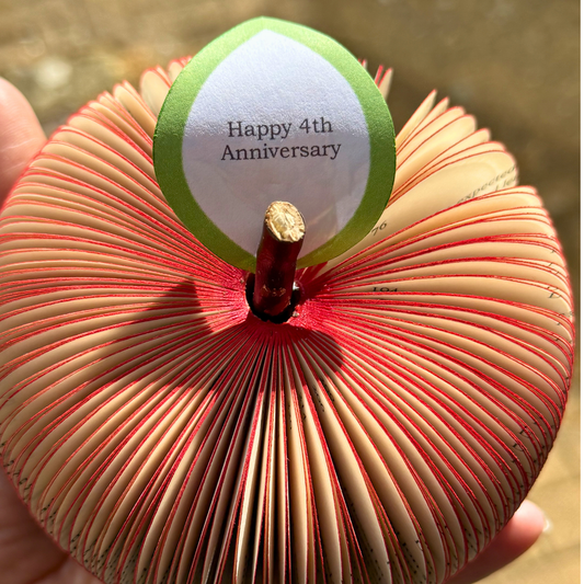 PS, I Love You book apple held in hands to show size, handmade paper anniversary gift