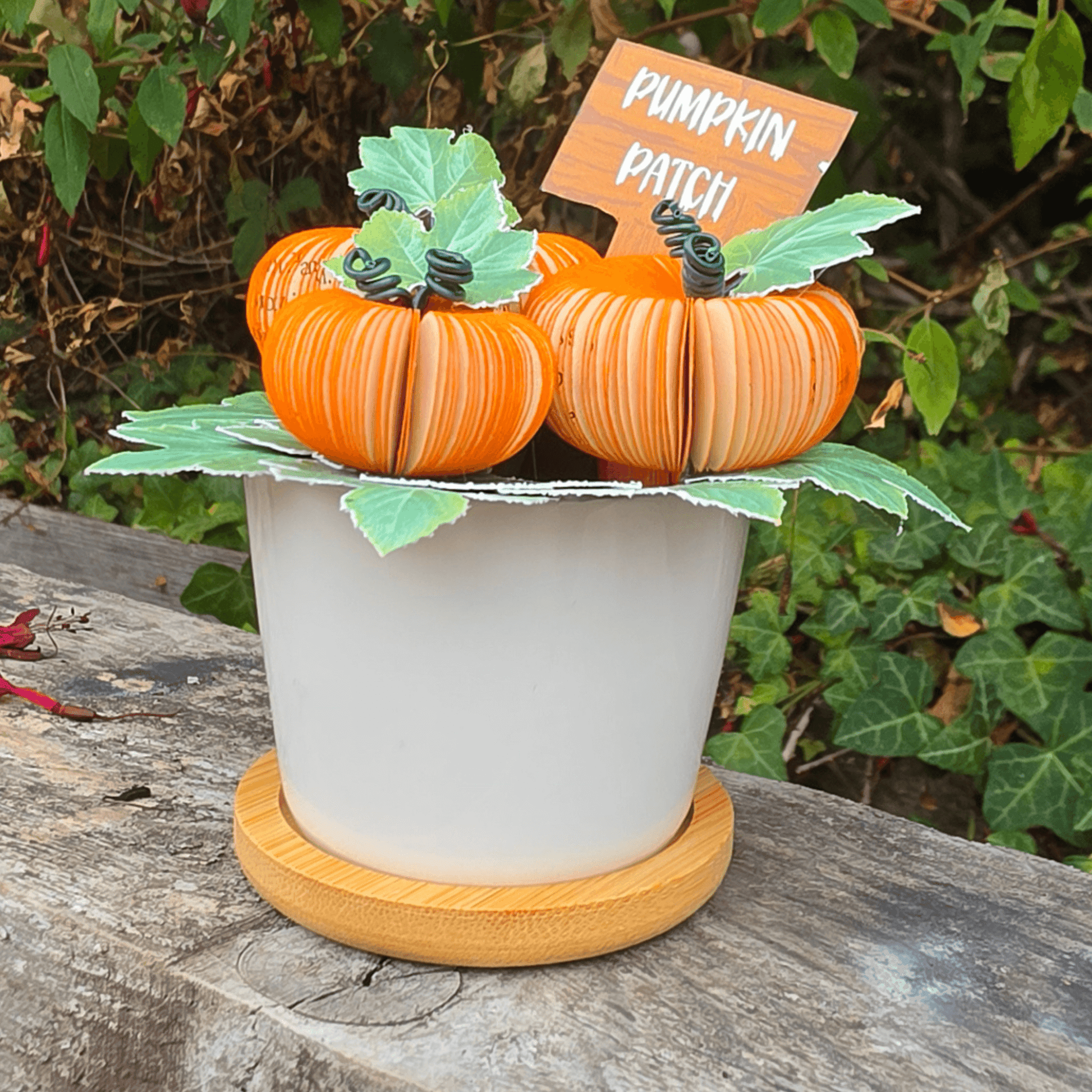 Pumpkin Patch Pot with hand-painted sign, handmade pumpkins hand-cut from book pages in a white ceramic pot