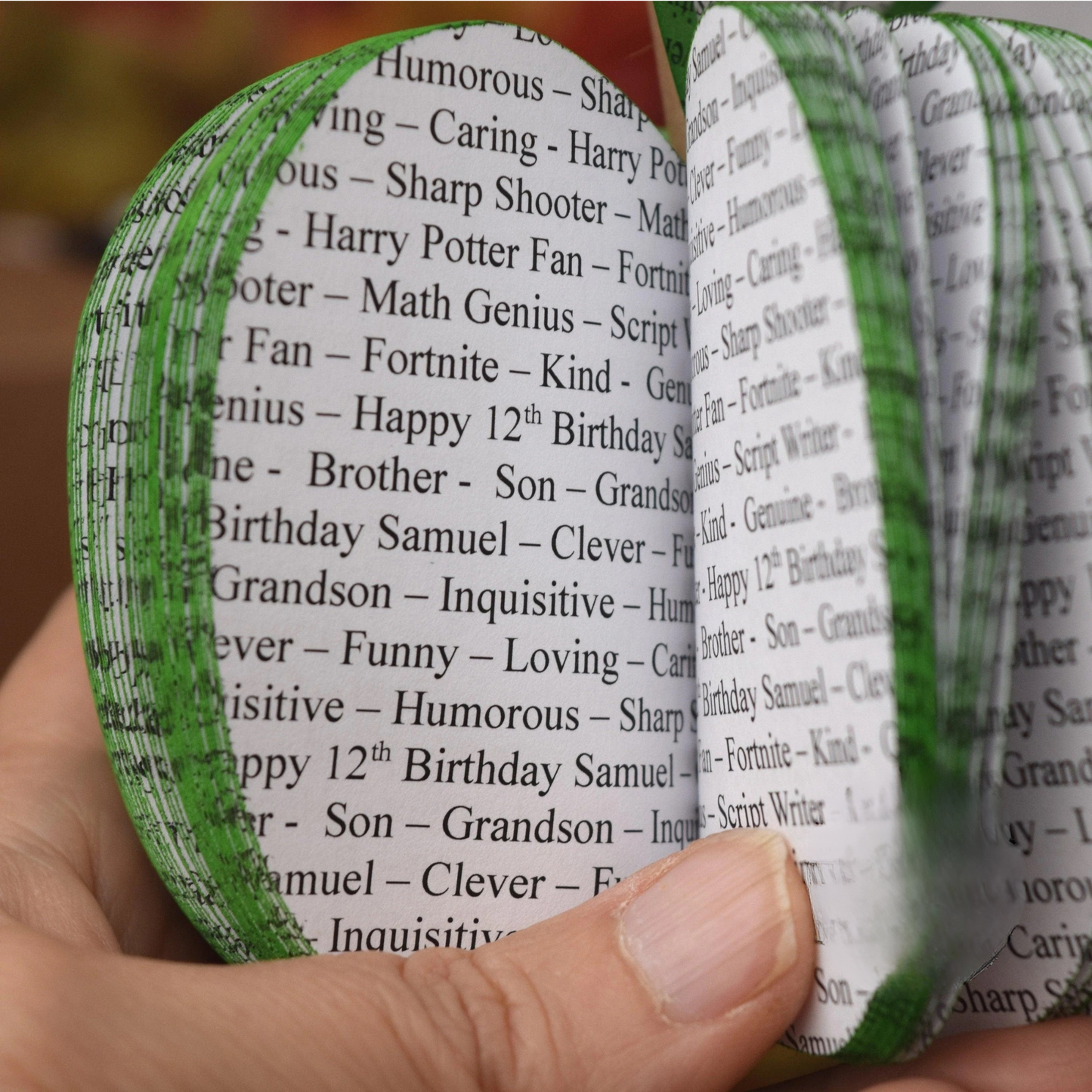 Close up of personalised song lyrics printed throughout handmade book apple sculpture.