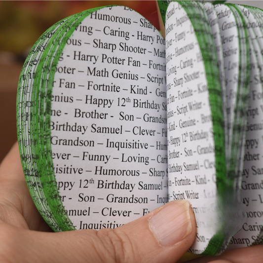 Close up of personalised song lyrics printed throughout handmade book apple sculpture.