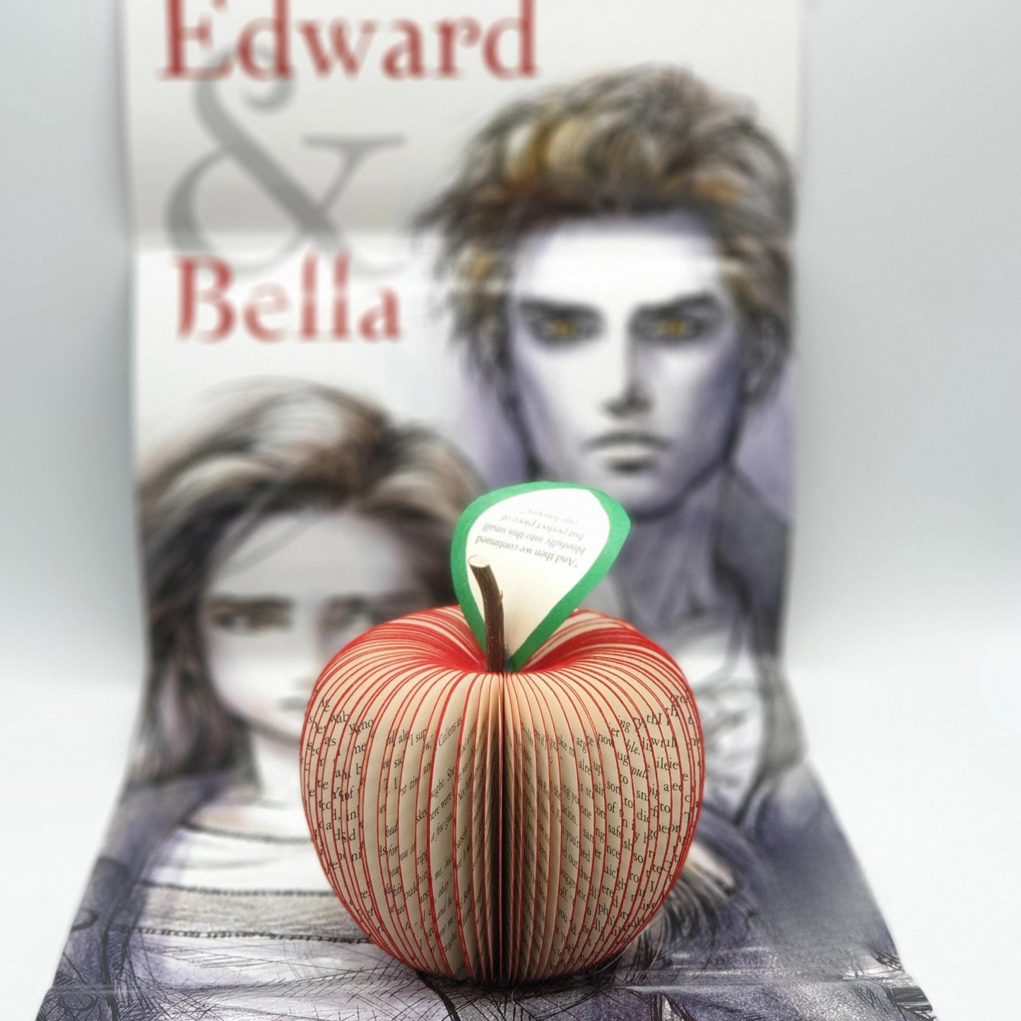 Personalised Twilight book page apple gift for fans displayed with Edward and Bella artwork background