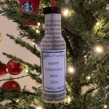 Close-up of Wine Bottle Hanging showing hand-cut book pages