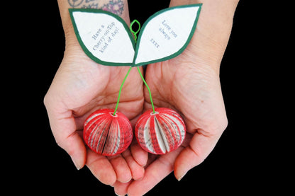 Close-up of Handmade book cherries showing hand-cut book pages detail