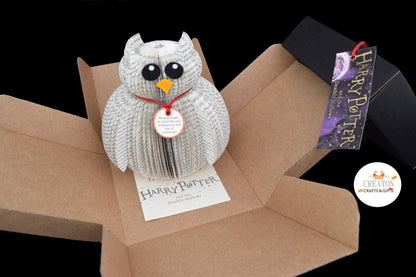 Hedwig displayed beside original Harry Potter book