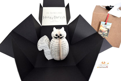 Close-up of Mini Crookshanks book sculpture showing hand-cut book pages