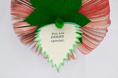 Close-up of Handmade book strawberry showing hand-cut book pages detail