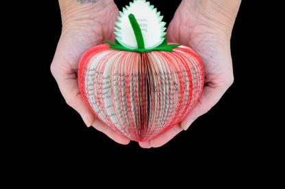 Handmade book strawberry held in hands to show size