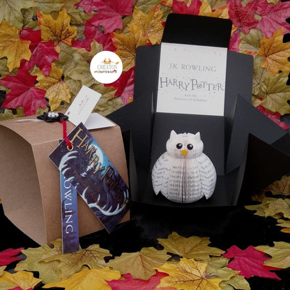 Mini Hedwig displayed beside original Harry Potter book