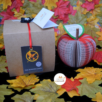 The Hunger Games book apple held in hands to show size, handmade paper anniversary gift