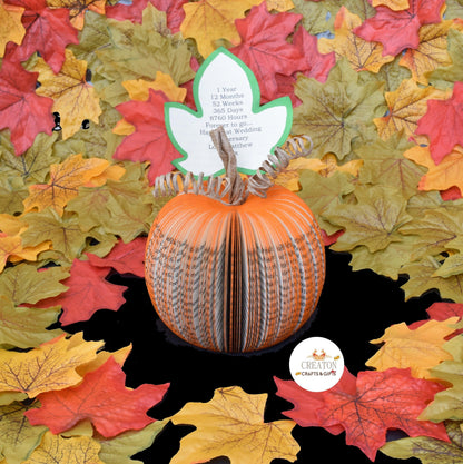 Handmade book page pumpkin displayed as autumn decoration