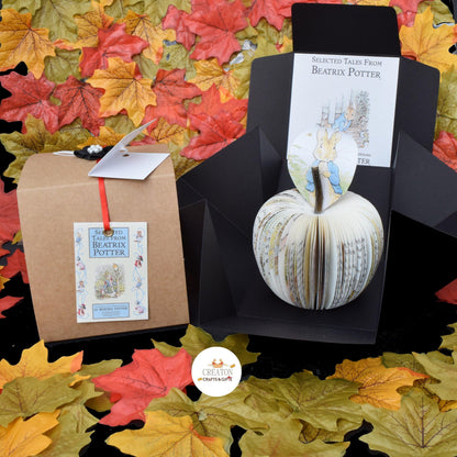 Peter Rabbit book apple held in hands to show size, handmade paper anniversary gift