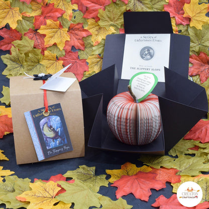 Series of Unfortunate Events book apple held in hands to show size, handmade paper anniversary gift