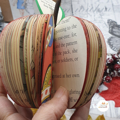 Alice in Wonderland book apple displayed beside original book