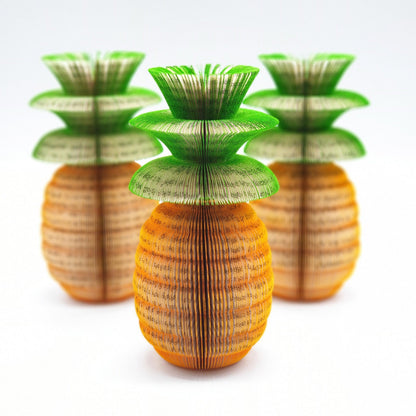 Close-up of Pineapple book apple showing hand-cut book pages detail