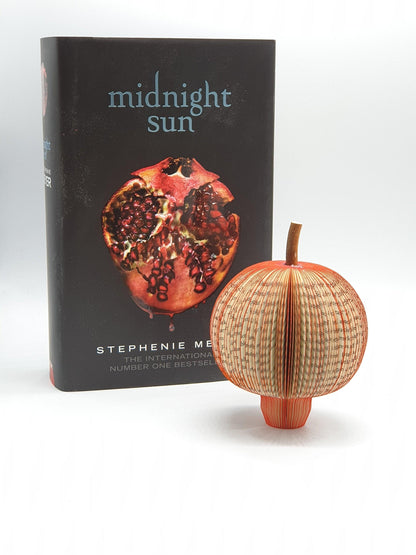 Close-up of Midnight Sun pomegranate book gift showing hand-cut book pages detail