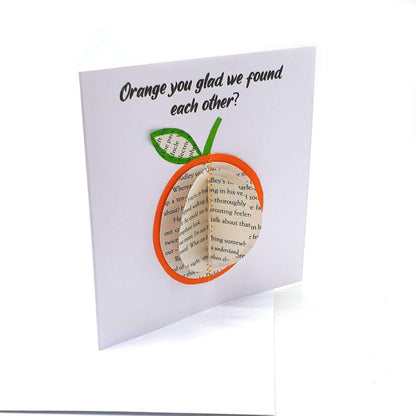 Orange gift card detail showing book page craftsmanship