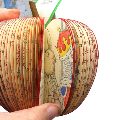 Alice in Wonderland book apple held in hands to show size, handmade paper anniversary gift