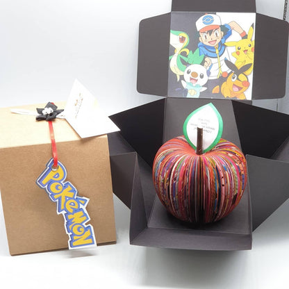 Close-up of Pokémon book apple showing hand-cut book pages detail