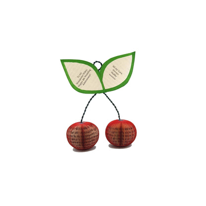 Handmade book cherries held in hands to show size