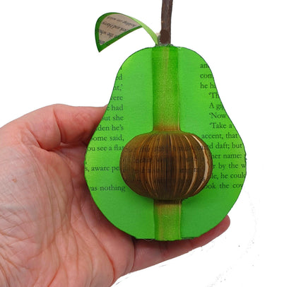 Close-up of handmade book avocado showing hand-cut book pages detail