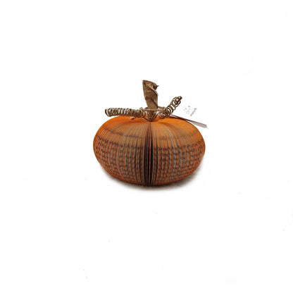 Small handmade book pumpkin held in hands to show size