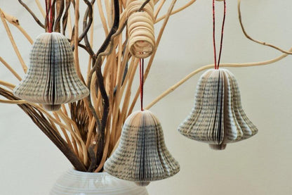 Hanging bell book decoration displayed on Christmas tree