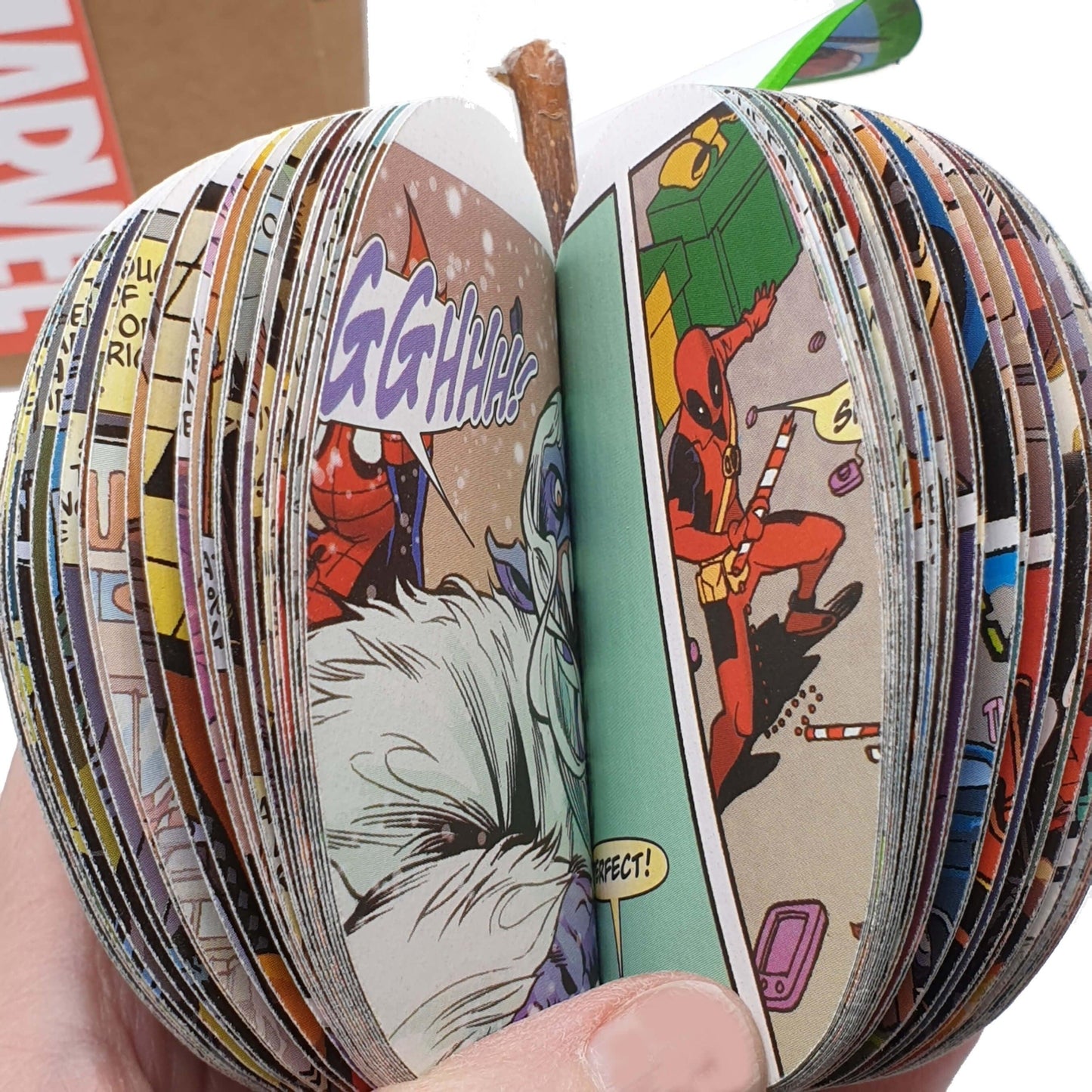 Close up of layered comic book pages inside handmade superhero apple gift