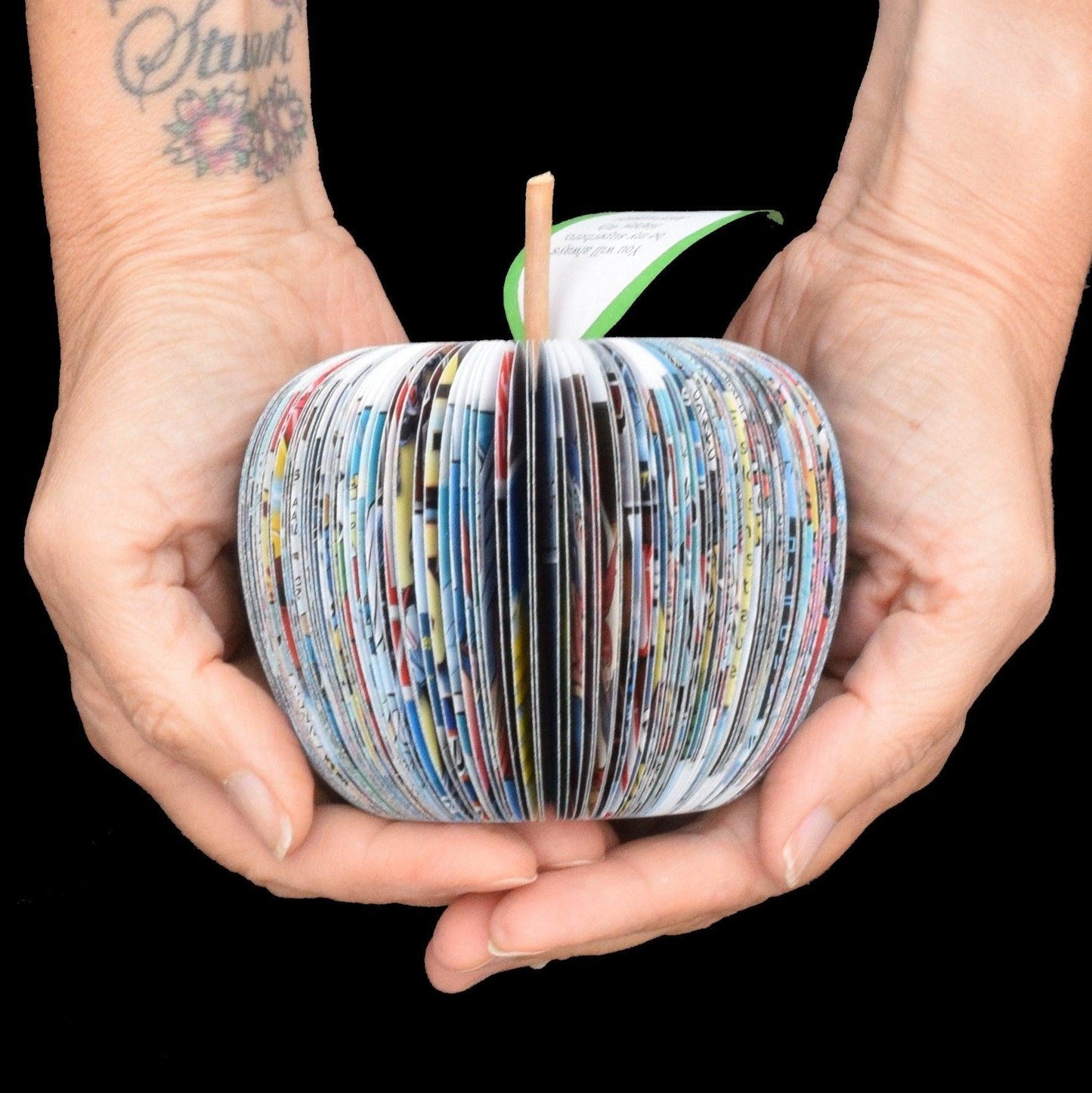 Superhero book apple shown in hands to demonstrate size approximately 9cm handmade anniversary gift